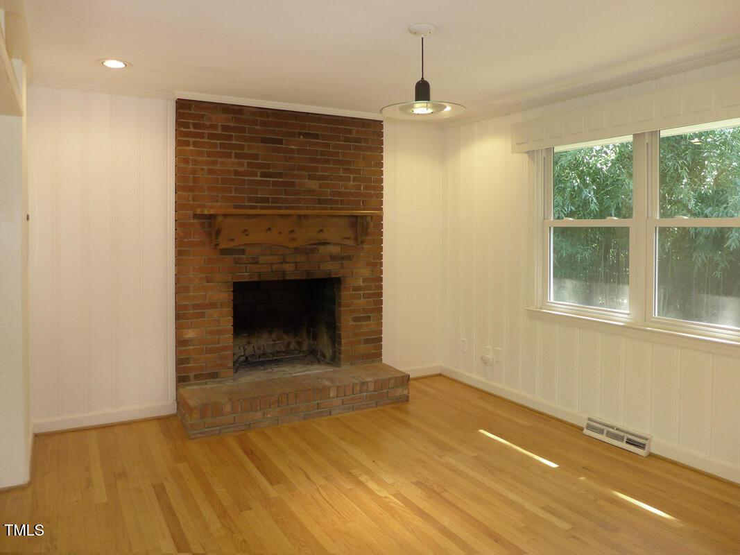 346 Wesley Drive Chapel Hill, NC 27516 - Photo 6 of 24 a view of an empty room with a fireplace and a window