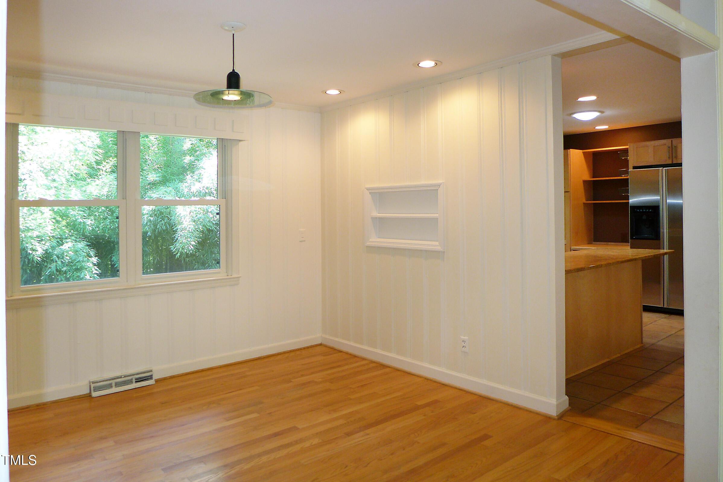 346 Wesley Drive Chapel Hill, NC 27516 - Photo 7 of 24 a view of an empty room with a window and wooden floor