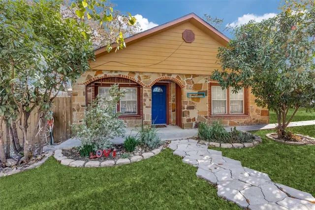a front view of a house with a garden