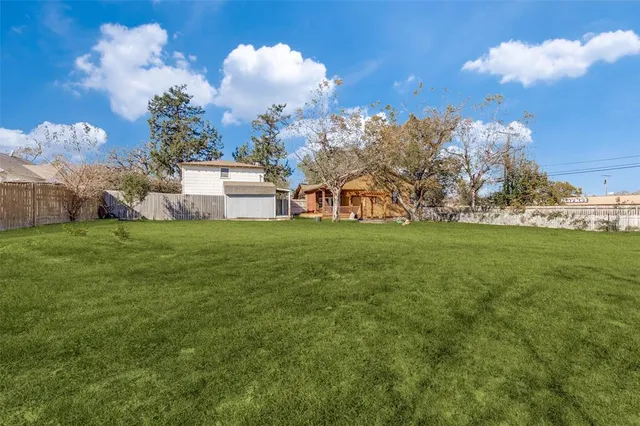 a view of yard with swimming pool and green space