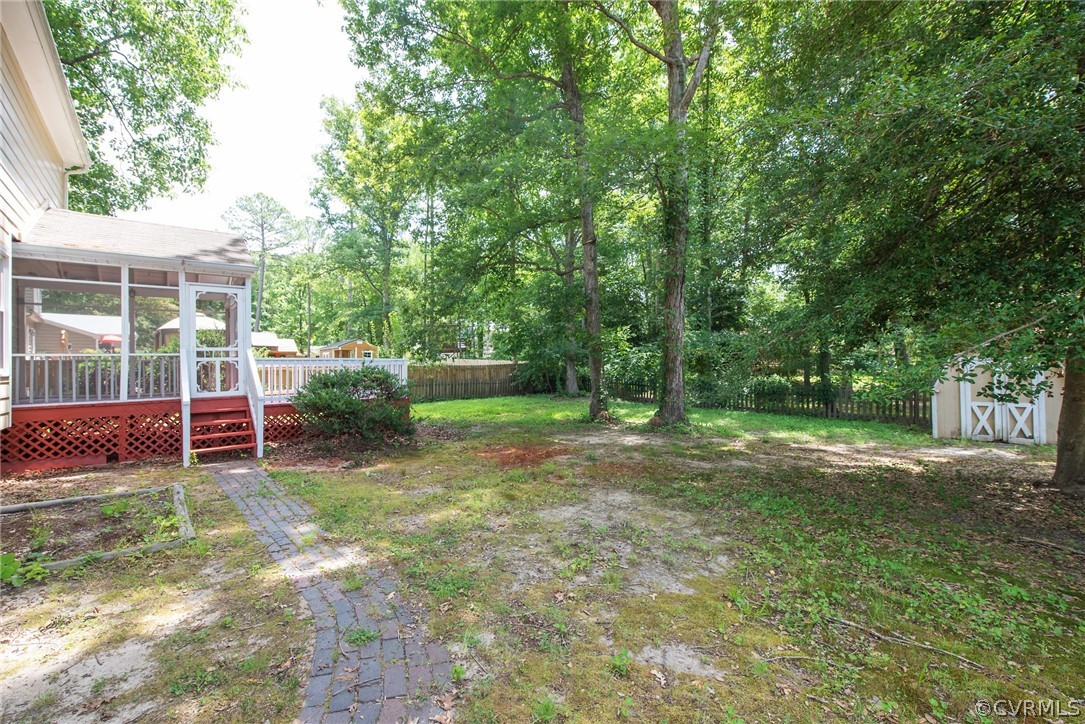 10613 Ridgerun Road Chesterfield, VA 23832 - Photo 43 of 46 a view of a backyard with table and chairs and wooden fence