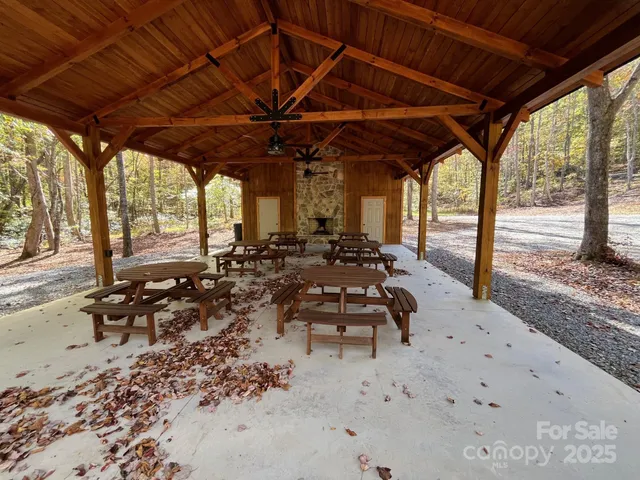 a view of a swimming pool with lawn chairs under an umbrella