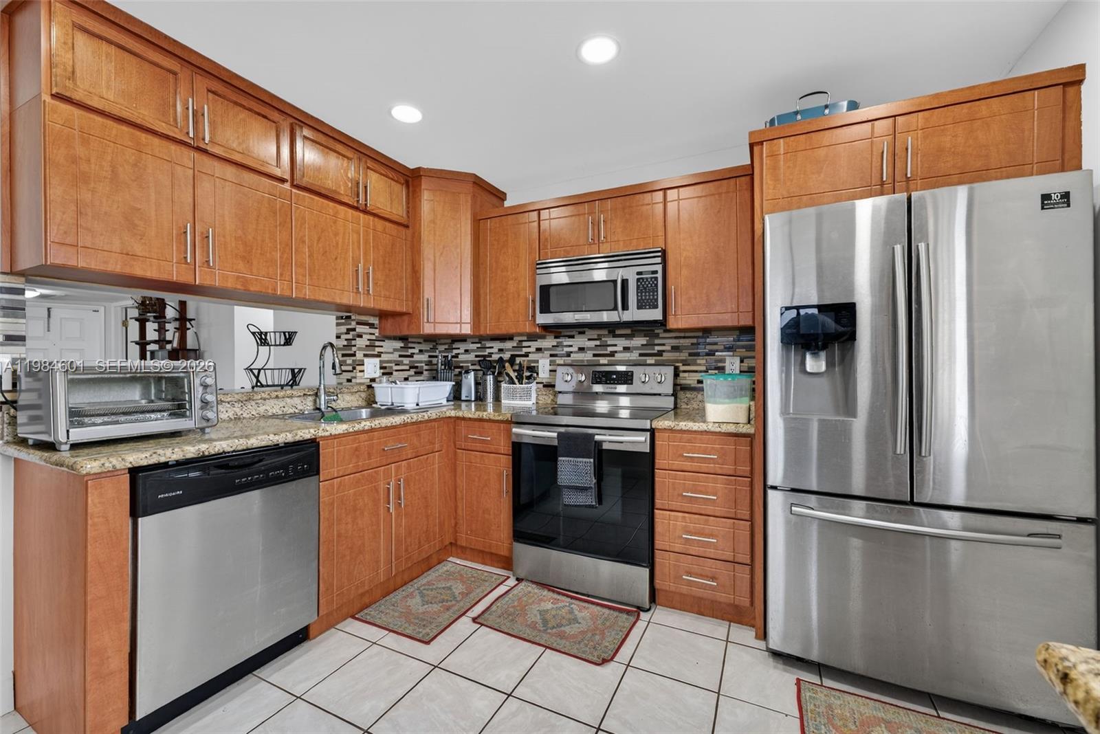 889 Hamilton Drive, Unit 889L Homestead, FL 33034 - Photo 12 of 28 a kitchen with stainless steel appliances a refrigerator sink and cabinets