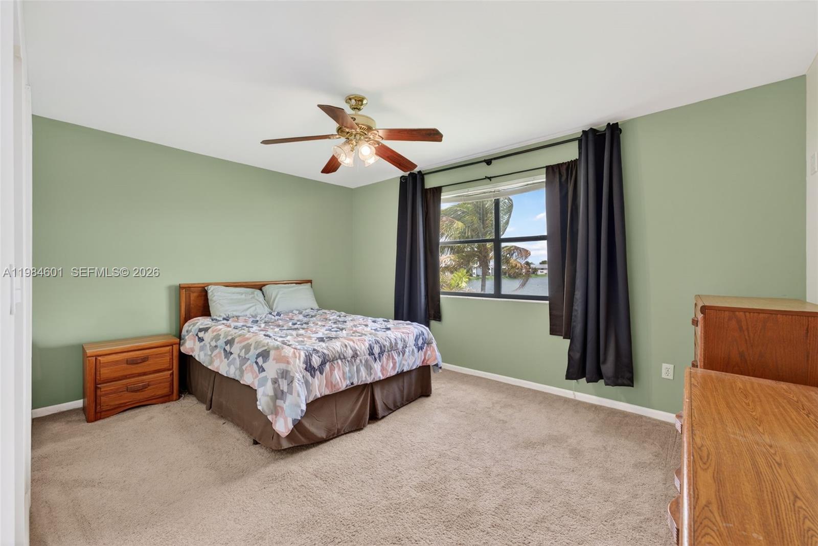 889 Hamilton Drive, Unit 889L Homestead, FL 33034 - Photo 14 of 28 a bedroom with a bed dresser and a window