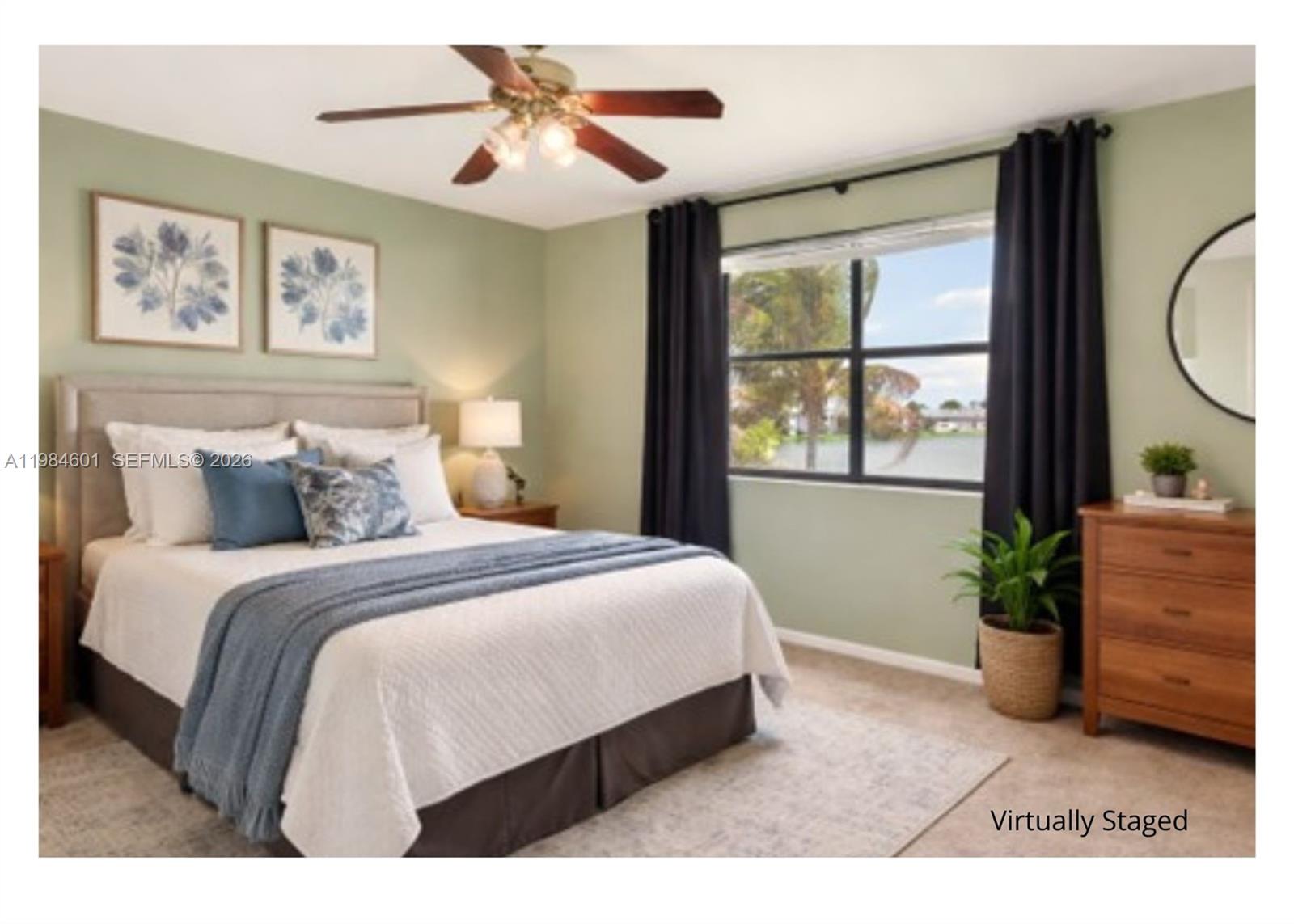 889 Hamilton Drive, Unit 889L Homestead, FL 33034 - Photo 15 of 28 a bedroom with a large bed and a chandelier