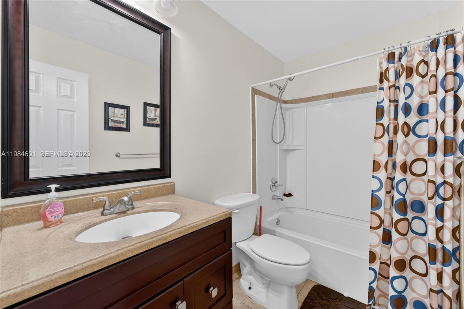 889 Hamilton Drive, Unit 889L Homestead, FL 33034 - Photo 19 of 28 a bathroom with a granite countertop sink toilet a mirror and shower