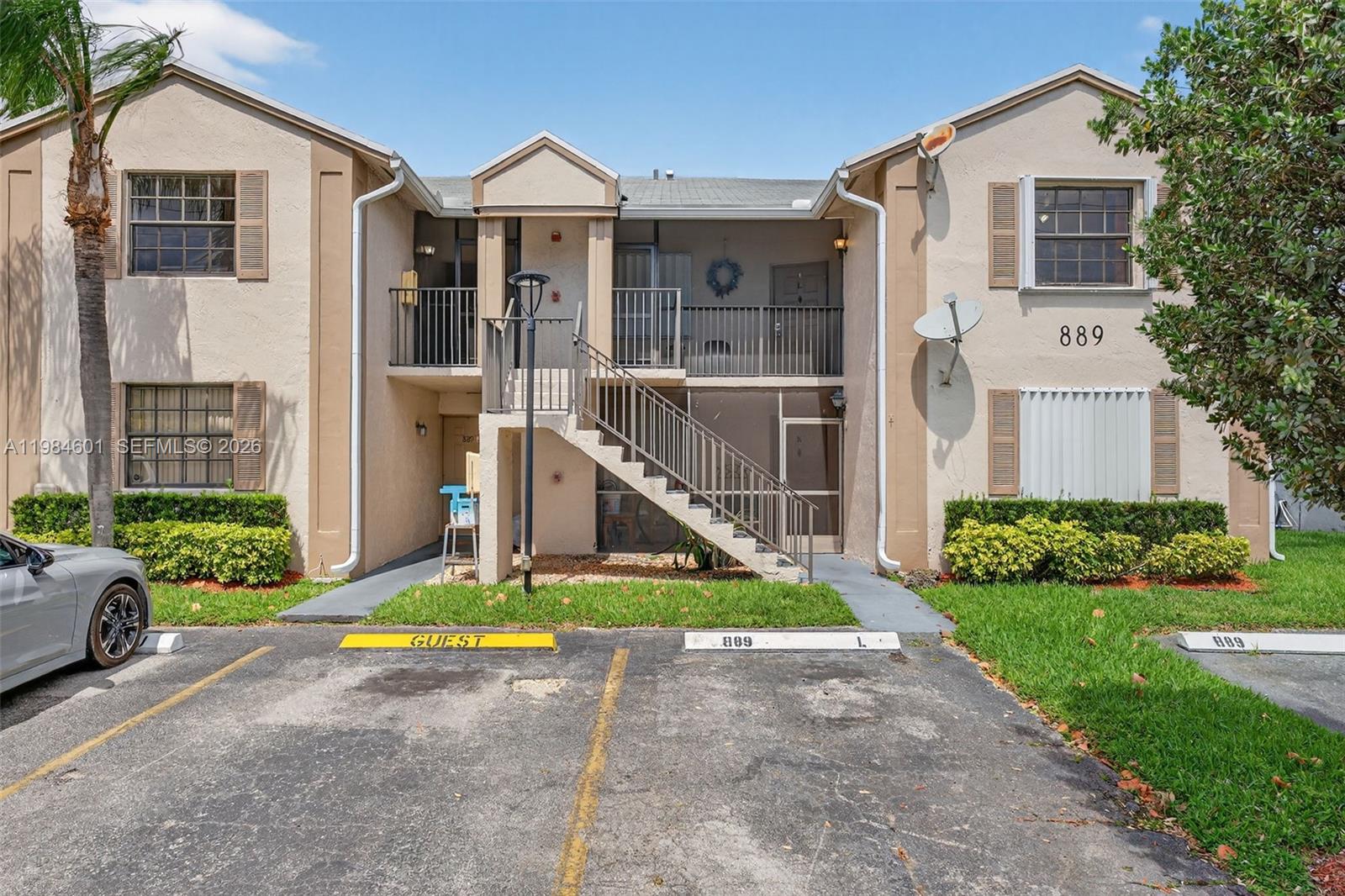 889 Hamilton Drive, Unit 889L Homestead, FL 33034 - Photo 2 of 28 a front view of a house with a yard and potted plants
