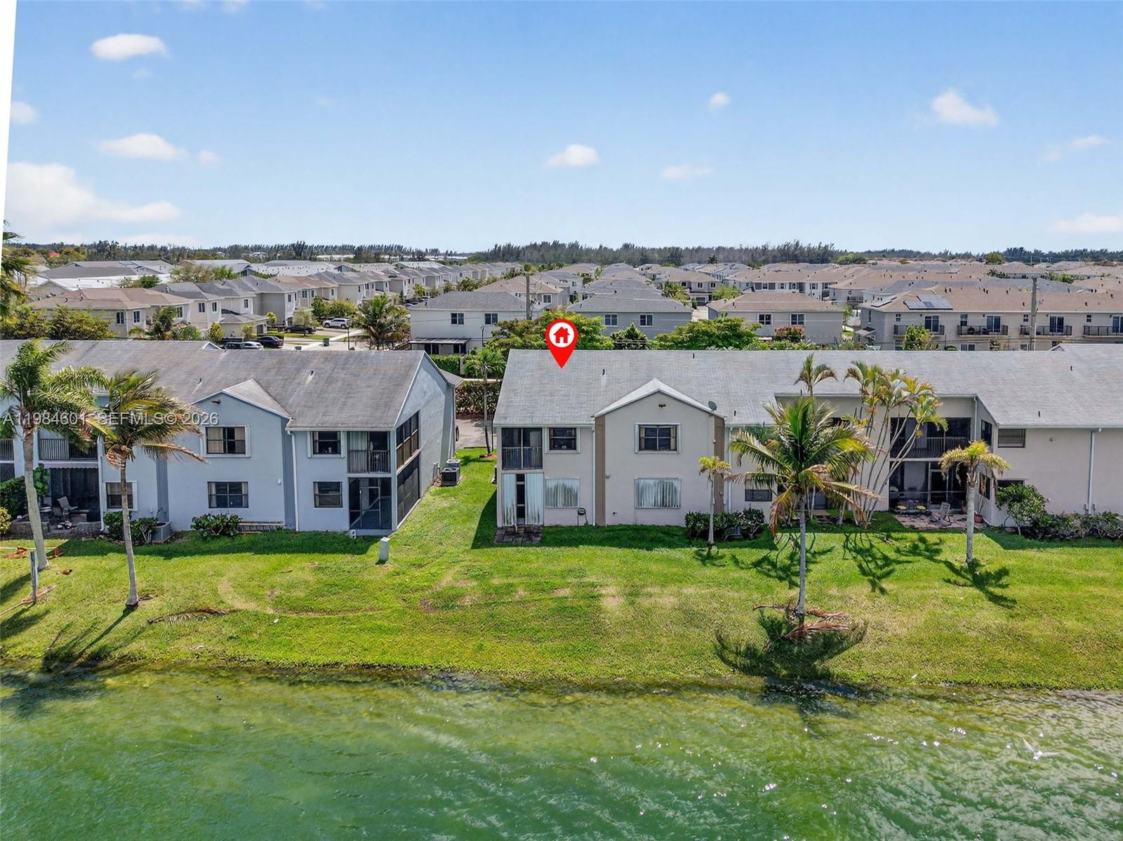 889 Hamilton Drive, Unit 889L Homestead, FL 33034 - Photo 25 of 28 an aerial view of residential houses with yard and mountain view in a big yard