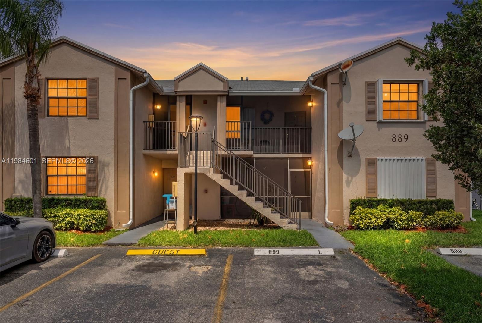889 Hamilton Drive, Unit 889L Homestead, FL 33034 - Photo 3 of 28 a view of a brick house with a yard and plants
