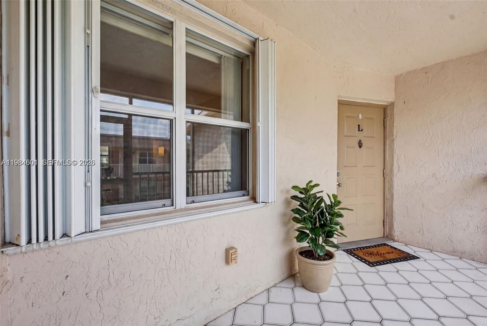 889 Hamilton Drive, Unit 889L Homestead, FL 33034 - Photo 4 of 28 a vase of flowers with a window