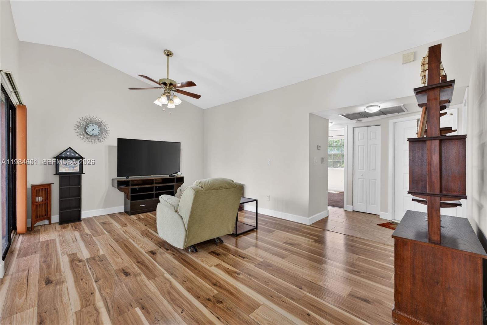 889 Hamilton Drive, Unit 889L Homestead, FL 33034 - Photo 8 of 28 a living room with furniture and a flat screen tv