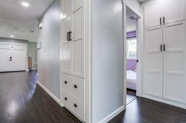 a view of hallway with wooden floor