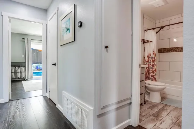 a bathroom with a toilet and a shower