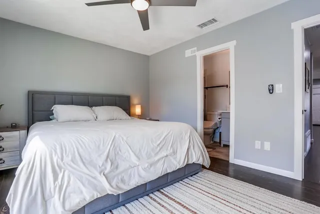 a bedroom with a bed and a mirror