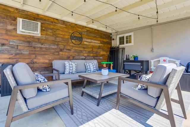 a view of a patio with a table and chairs