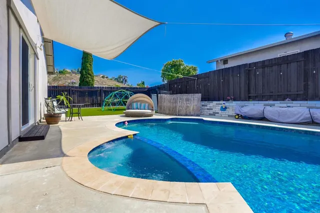 a view of a house with swimming pool and porch