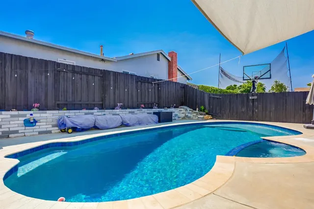 a view of a chairs and table in the backyard