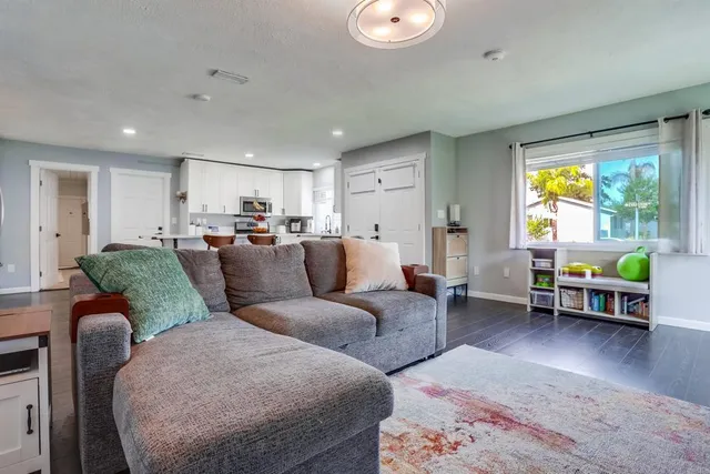 a living room with furniture and a dining table