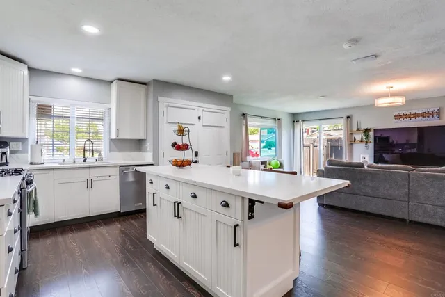 a kitchen with counter top space sink and center island
