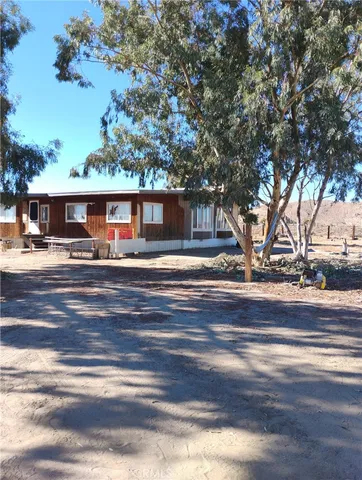 a front view of a house with a fountain