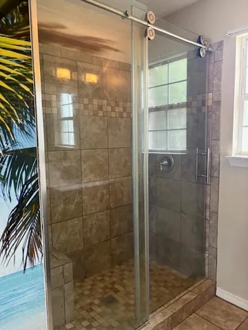 a bathroom with a glass door shower
