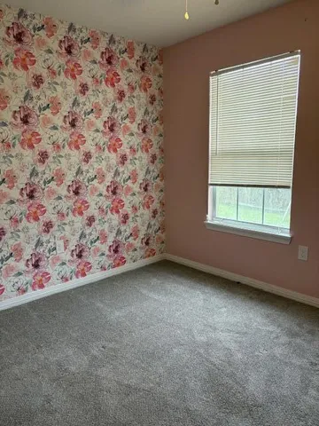 an empty room with a fireplace