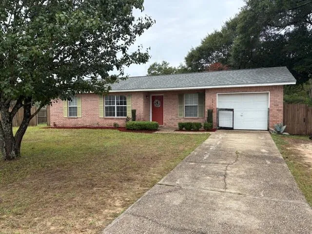 a front view of house with yard and trees