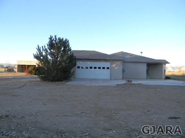 976 20 Road Fruita, CO 81521 - Photo 5 of 16 a view of a house with a yard and garage