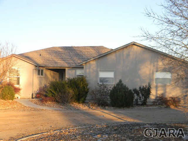 976 20 Road Fruita, CO 81521 - Photo 9 of 16 a yellow house with tree in front of it