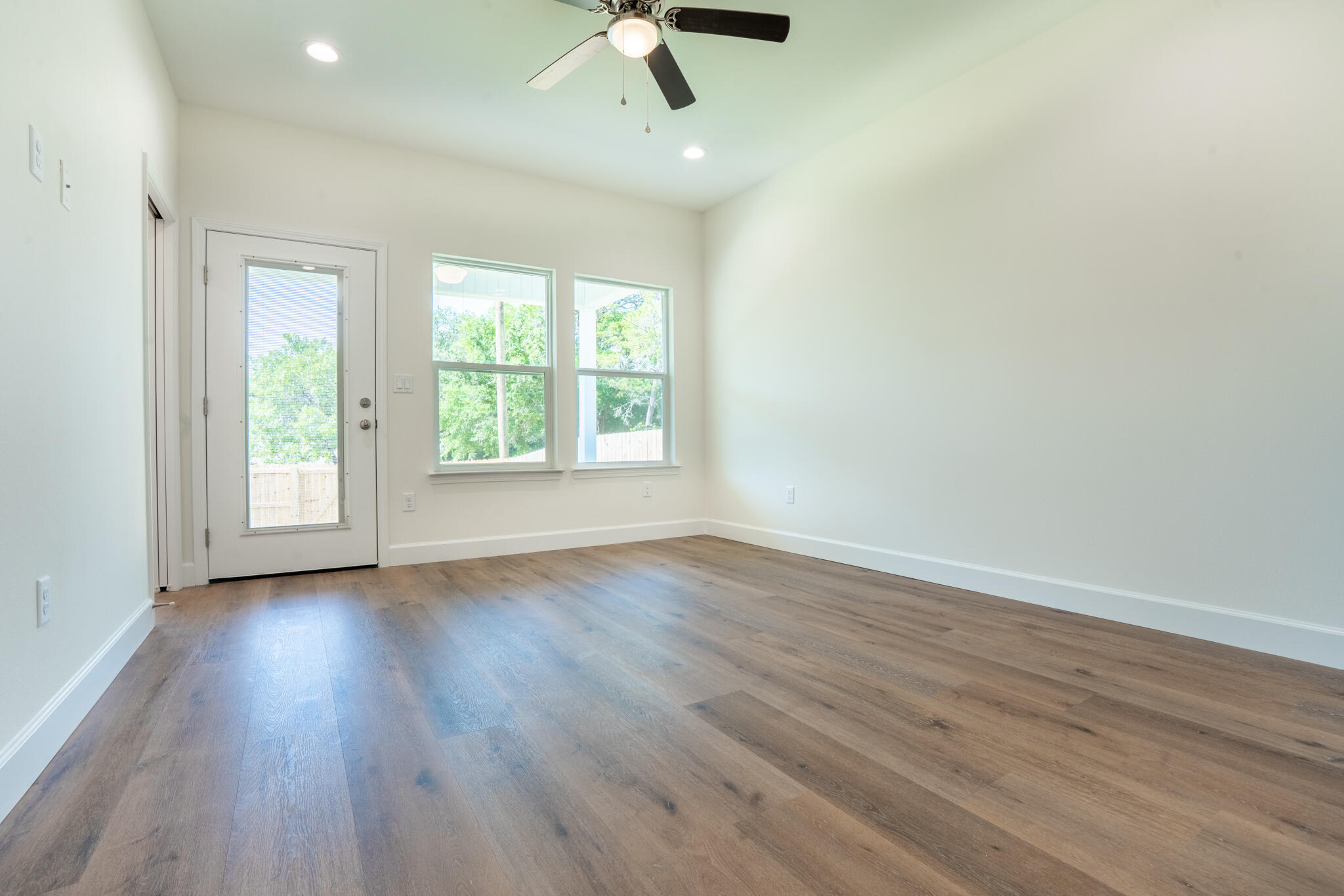 110 2nd Avenue Shalimar, FL 32579 - Photo 12 of 15 an empty room with wooden floor fan and windows