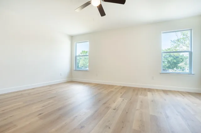wooden floor in an empty room with a window