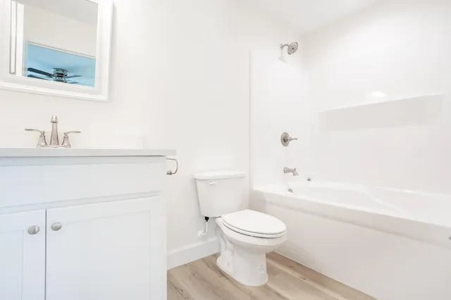 a white toilet sitting next to a bathroom sink