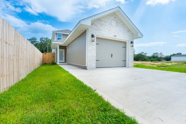 a view of a house with a yard and garage