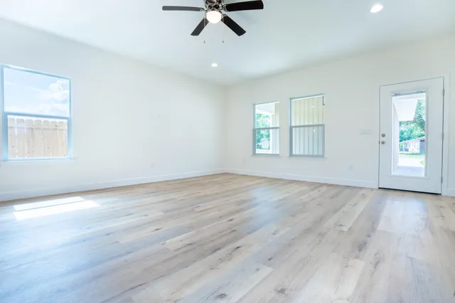 wooden floor in an empty room with a window