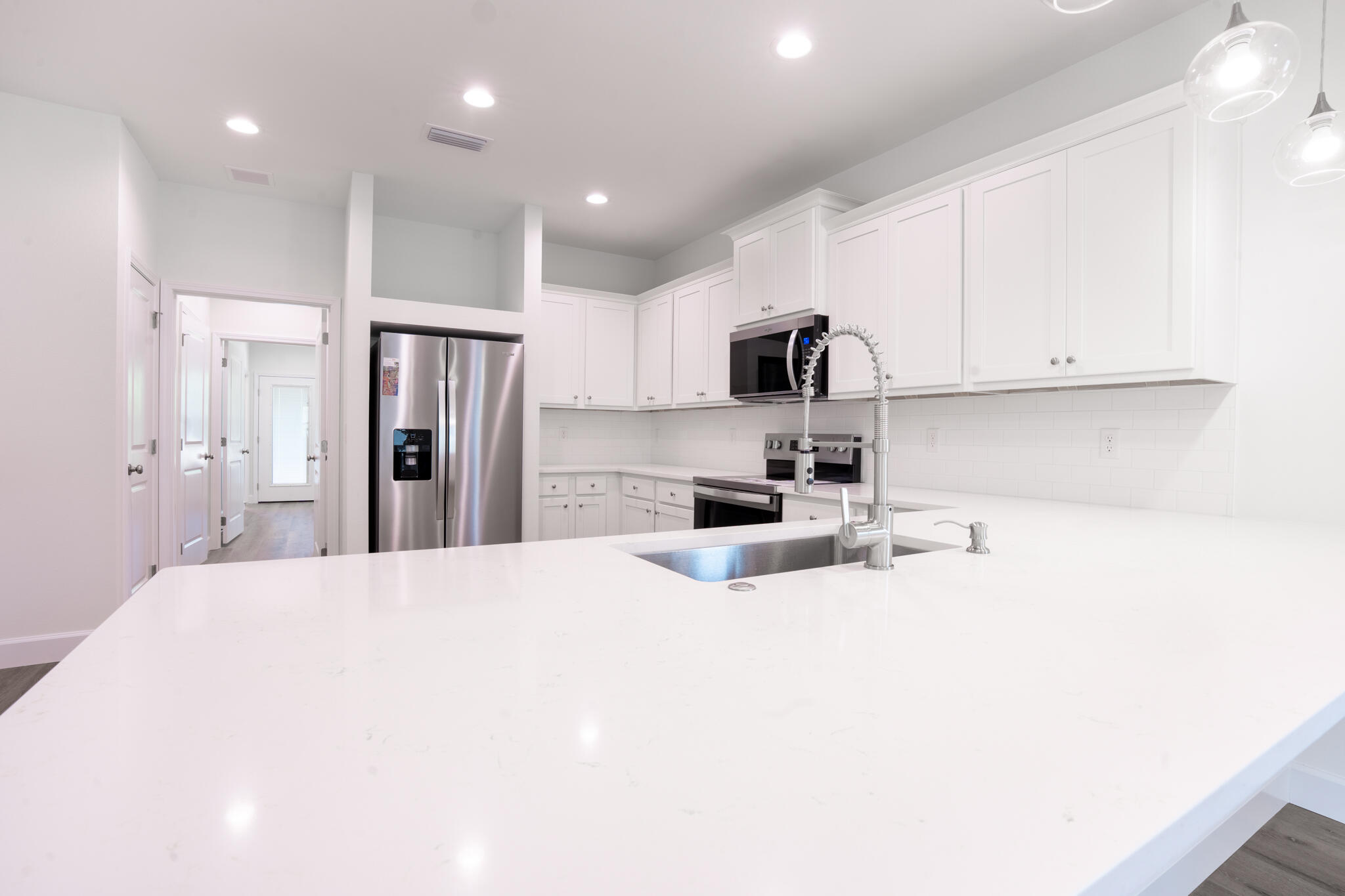 110 2nd Avenue Shalimar, FL 32579 - Photo 7 of 15 a kitchen with stainless steel appliances a refrigerator stove microwave and cabinets