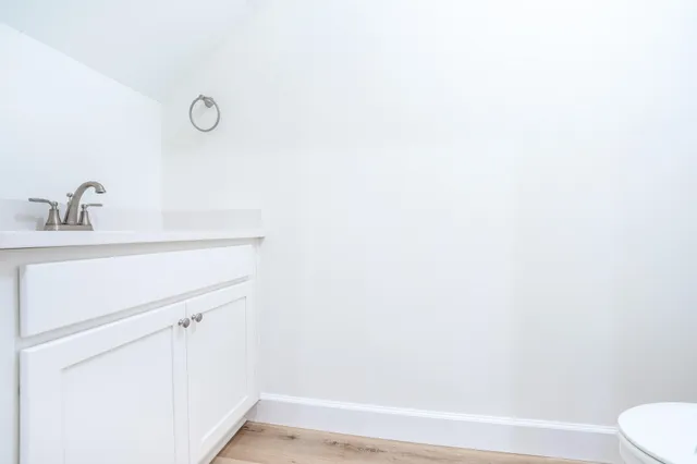 a bathroom with a sink a toilet and vanity