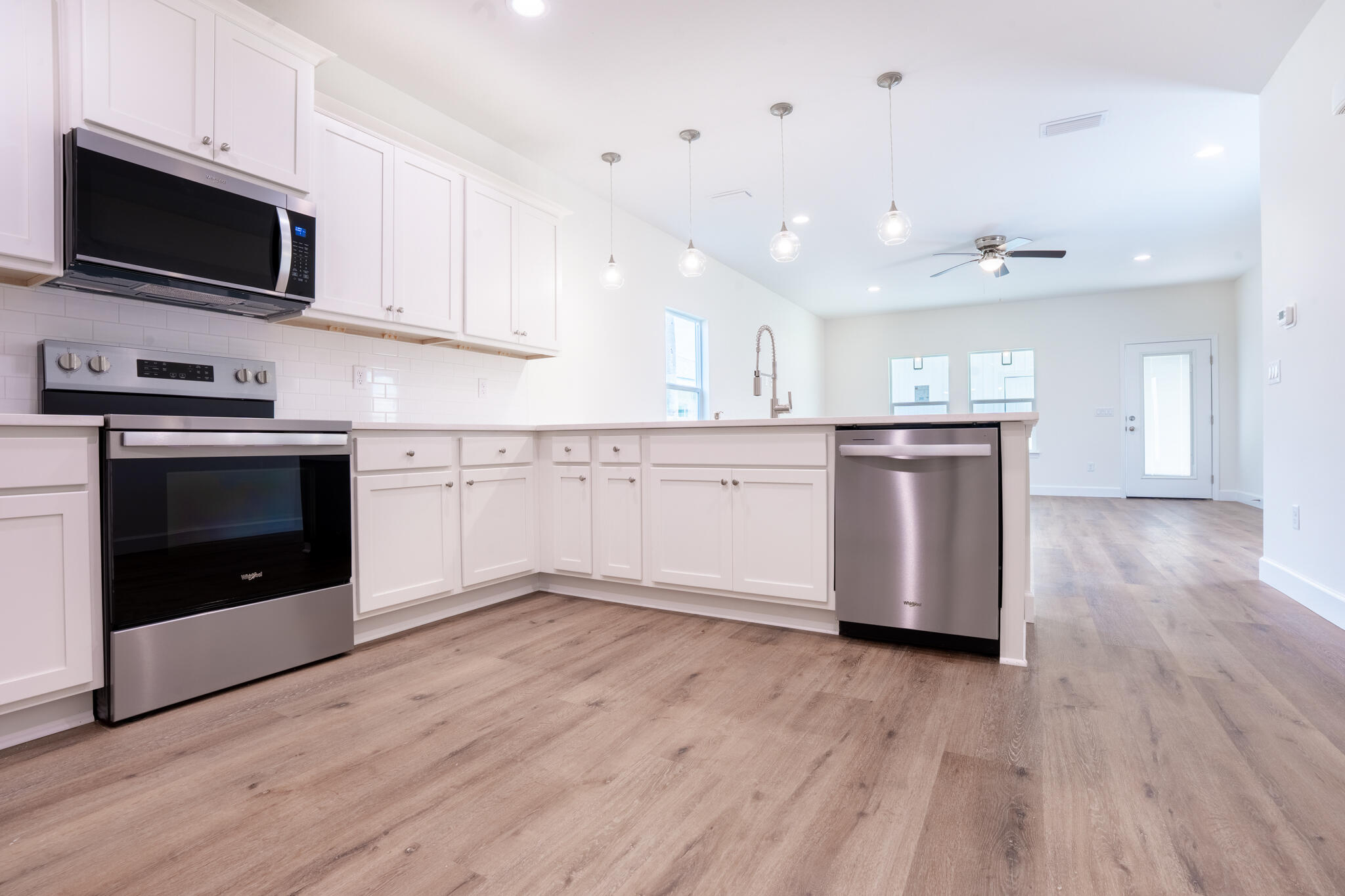 110 2nd Avenue Shalimar, FL 32579 - Photo 10 of 15 a kitchen with stainless steel appliances granite countertop a stove top oven a sink and a microwave