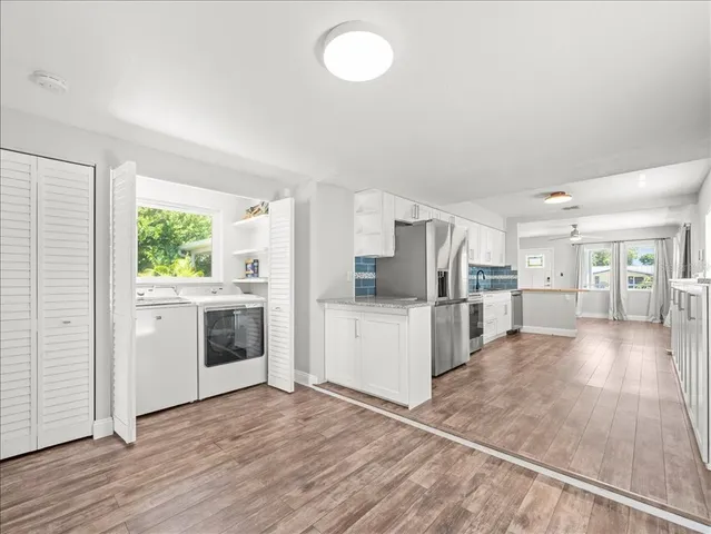 a kitchen with a refrigerator and a stove top oven