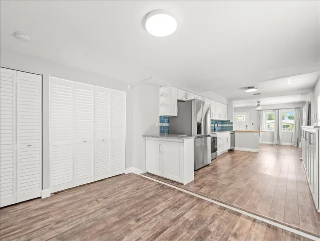 a view of kitchen with wooden floor