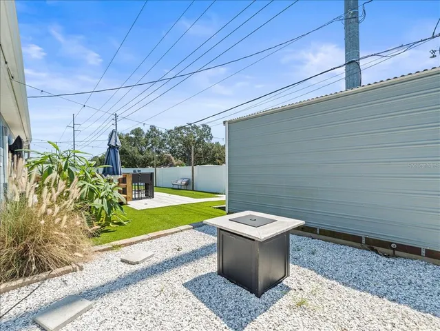a view of a backyard with sitting area