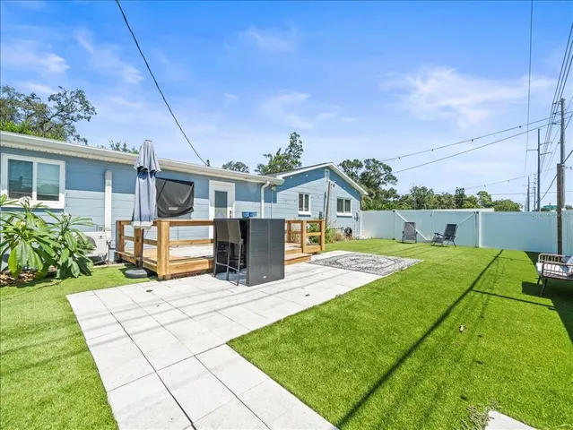 a view of a house with patio and a yard