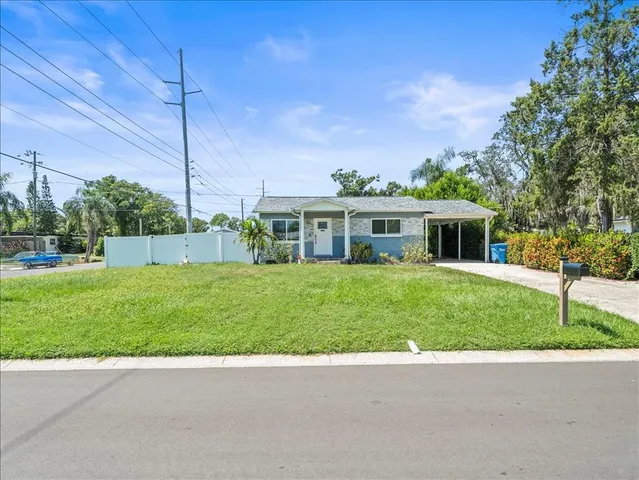 a view of house with a back yard