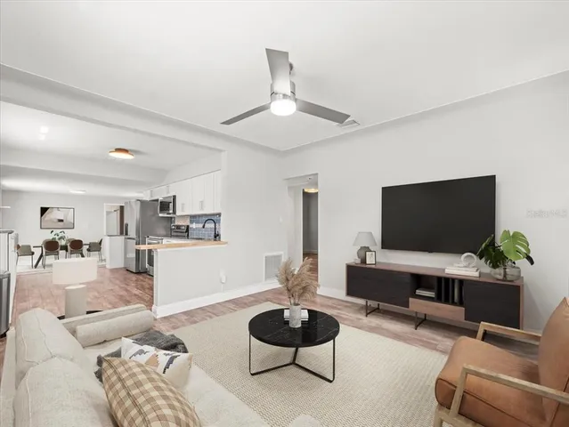 a living room with furniture and a flat screen tv