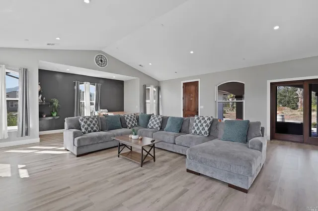 a living room with furniture and wooden floor