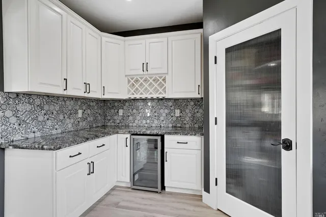 a kitchen with white cabinets and white appliances