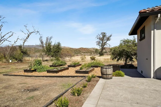 a view of a backyard with sitting area