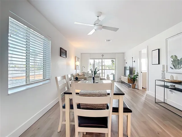 a kitchen with stainless steel appliances a stove and white cabinets