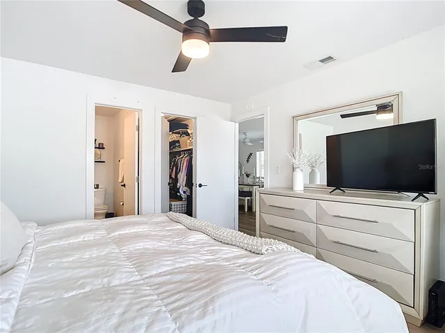 a bedroom with a large bed and a window