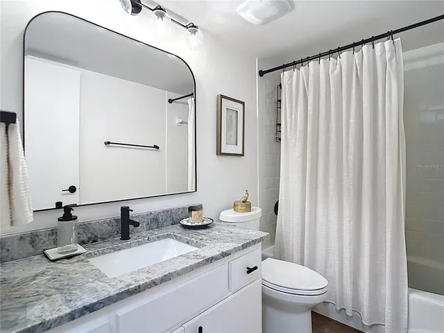 a bedroom with two beds and painting on the wall