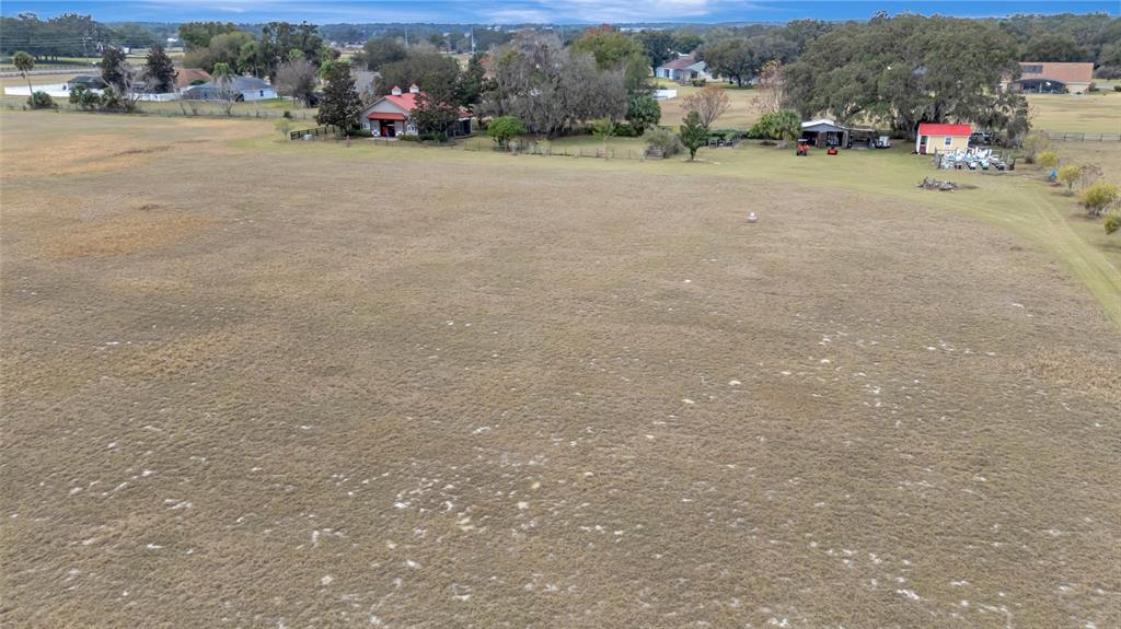 Wolf Branch Road Sorrento, FL 32776 - Photo 28 of 33 a view of dirt road with a building and trees in the background